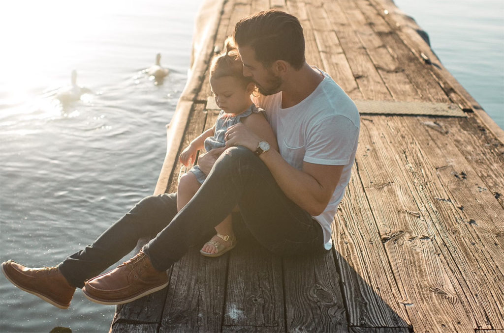 family by water in jeans